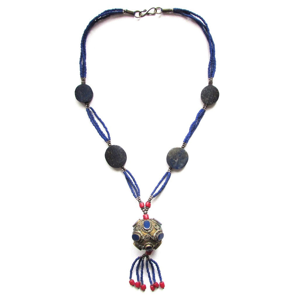 Lapis Antique Orb Tassel Necklace beaded tassel with coral accent hang from an antiqued orb finished in indigo beads and Lapis stations