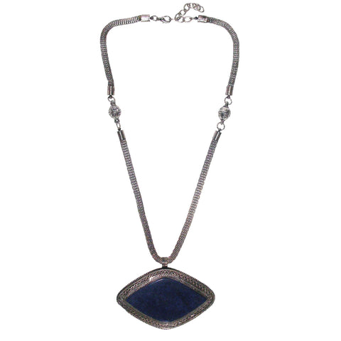 Mavi Turkoman Lapis Lazuli Tribal Necklace is fashioned with a large size deep blue stone medallion set on intricately carved silver tone base finished with a mesh wire chain.