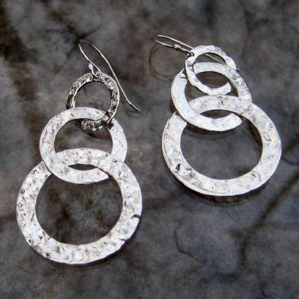 Sterling Silver Graduated Circle Dangle Earrings.  These hammered silver earrings feature dangling graduated circles creating delightful movement and reflecting light