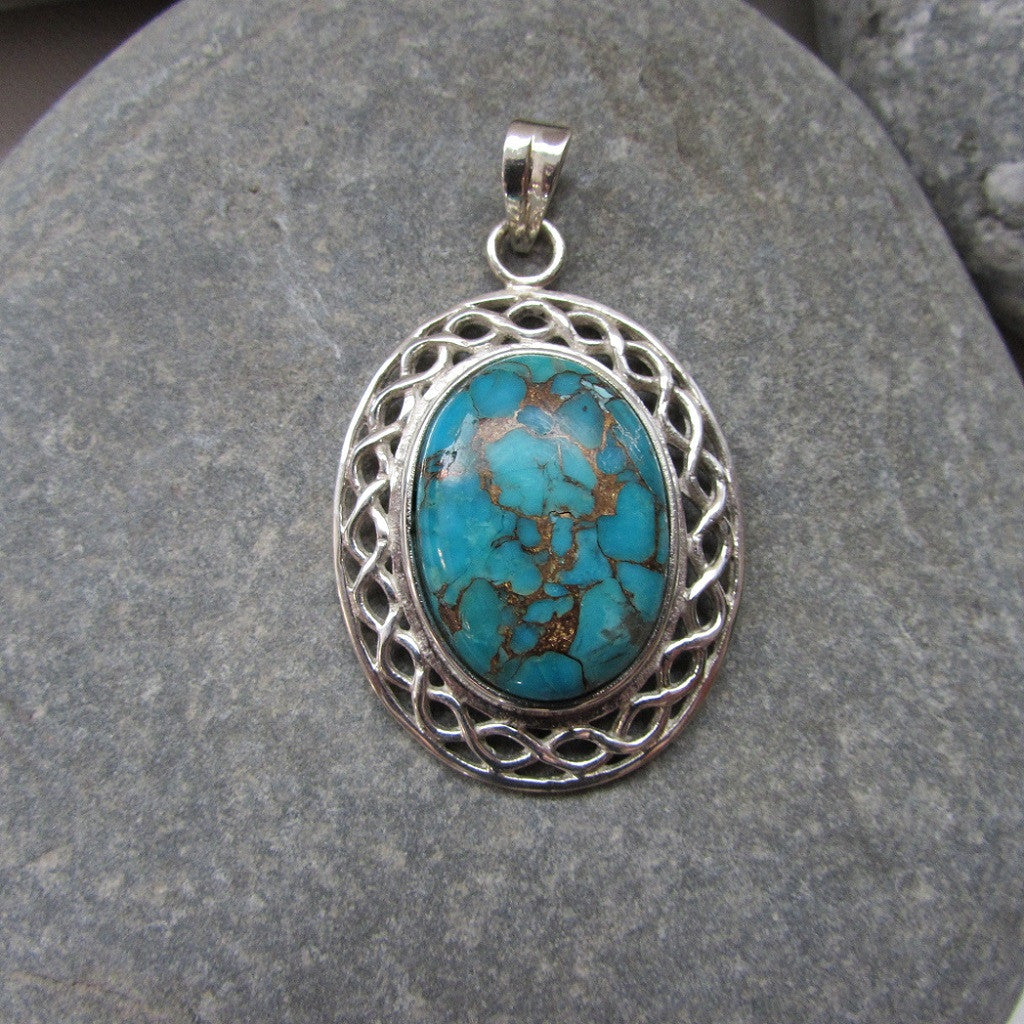 Sterling Silver Copper Turquoise Oval Pendant  features a turquoise stone set in a Celtic knot motif symbolizing the harmonious weaving together of two paths