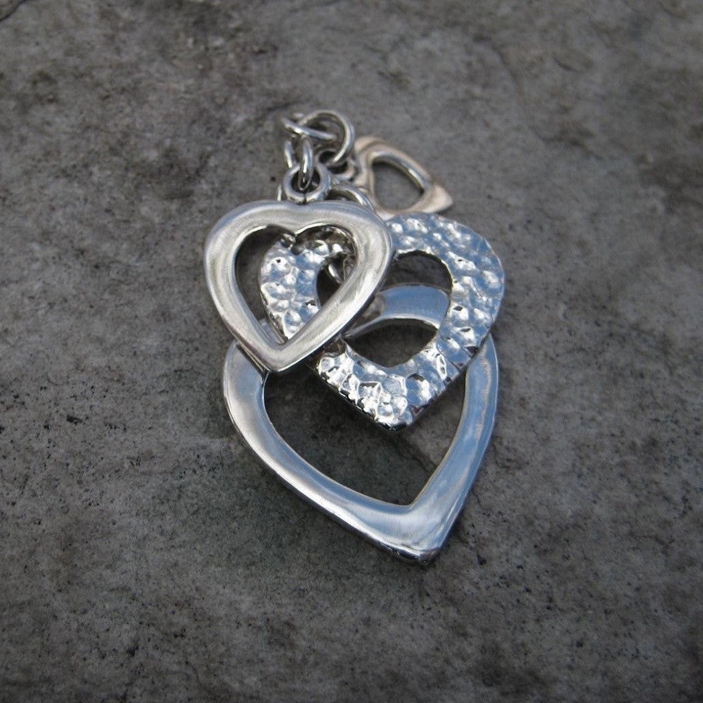 Sterling Silver Multi Heart Pendant features four Sterling Silver graduated cascading hearts in polished and hammered finish