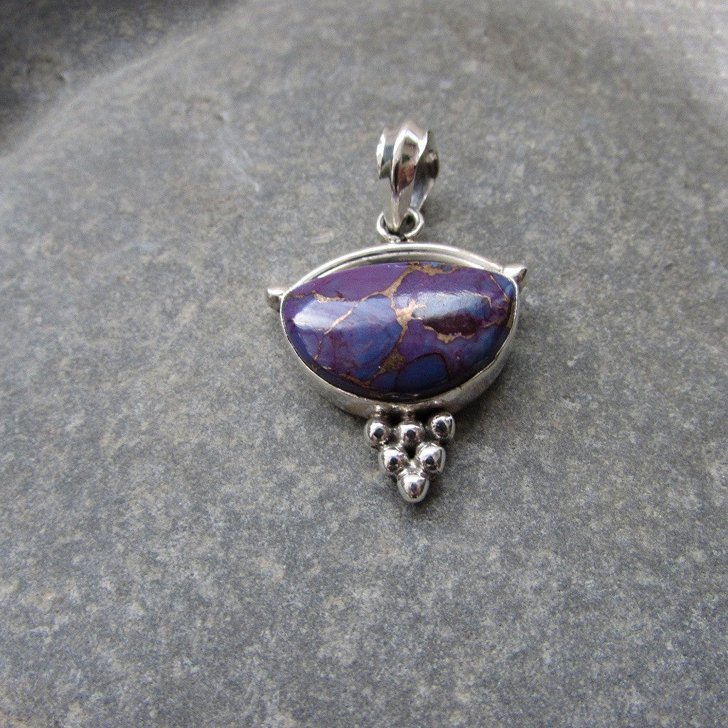 Sterling Silver Purple Copper Turquoise Pendant features a generous size half moon shaped cut Purple Copper Turquoise gemstone finished with silver honeycomb motif