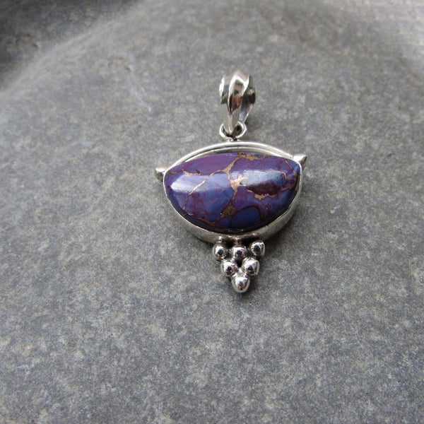 Sterling Silver Purple Copper Turquoise Pendant features a generous size half moon shaped cut Purple Copper Turquoise gemstone finished with silver honeycomb motif