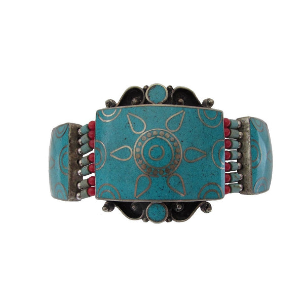 Turquoise Metal Work Bracelet 'Zar' in silver tone metal and turquoise with coral bead accent  features a sectional inlay of turquoise with delicate filigree design in silver tone